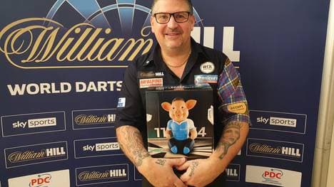 Gary Anderson freut sich über sein Phrasenschwein von SPORT1