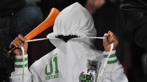 A young supporter of Italy hides his fac