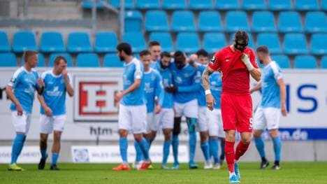 Während Kaiserslauterns Timmy Thiele hadert, jubeln im Hintergrund die Chemnitzer Spieler