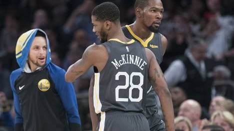 Alfonzo McKinnie wird von seinen Teamkollegen um Steph Curry (l.) gelobt