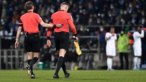 Referee Benjamin Cortus (l.) brach das Spiel zwischen dem VfL Bochum gegen Borussia Mönchengladbach ab, nachdem Schiedsrichterassistent Christian Gittelmann von einem vollen Bierbecher getroffen wurde