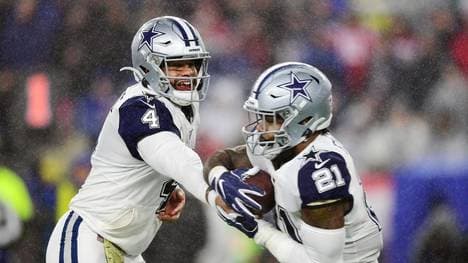 FOXBOROUGH, MASSACHUSETTS - NOVEMBER 24: Dak Prescott #4 of the Dallas Cowboys hands off to Ezekiel Elliott #21 during the first half against the New England Patriots in the game at Gillette Stadium on November 24, 2019 in Foxborough, Massachusetts. (Photo by Billie Weiss/Getty Images)