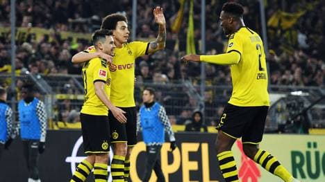 DORTMUND, GERMANY - FEBRUARY 14: Raphael Guerreiro of Dortmund celebrates his team's fourth goal with team mates Axel Witsel and Dan-Axel Zagadou (L-R) during the Bundesliga match between Borussia Dortmund and Eintracht Frankfurt at Signal Iduna Park on February 14, 2020 in Dortmund, Germany. (Photo by Jörg Schüler/Bongarts/Getty Images)