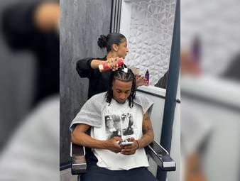 Michael Olise gönnt sich eine kleine Auszeit beim Friseur. Vor der Weltmeisterschaft müssen erstmal die Schäden der aktuellen Feierlichkeiten mit dem FC Bayern behoben werden. 