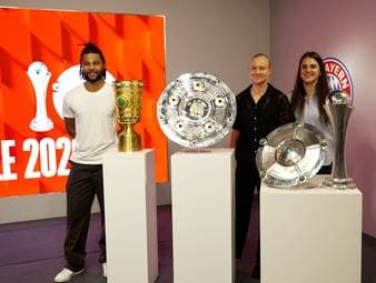 Der FC Bayern feiert sein erstes doppeltes Double der Vereinsgeschichte: Meisterschaft und Pokal für Männer und Frauen. Serge Gnabry, Jovana Damnjanovic und Pernille Harder präsentieren die Trophäen.