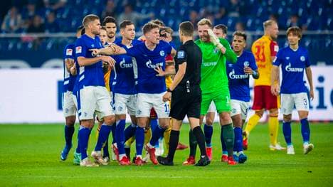 Schalke diskutiert mit Schiri Christof Günsch nach dem Platzverweis von Victor Palsson