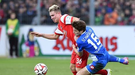 Felix Klaus (L) of SC Freiburg challenges Pirmin Schwegler