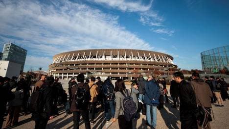 Journalists visit the National Stadium, venue for the upcoming Tokyo 2020 Olympic Games, during a media tour following the stadium's completion in Tokyo on December 15, 2019. - The Tokyo 2020 Olympics organisers on December 15 celebrated the completion of the main stadium that features use of lumber and other Japanese architectural tradition, seven months before the Opening Ceremony. (Photo by Behrouz MEHRI / AFP) (Photo by BEHROUZ MEHRI/AFP via Getty Images)
