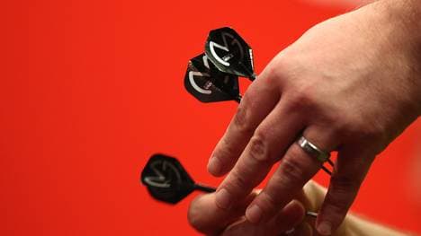LONDON, ENGLAND - DECEMBER 22: Michael Van Gerwen of Holland holds his darts with his MVG logo on his flights during his second round match against Kevin McDine of England during the Ladbrokes.com World Darts Championship on Day Ten at Alexandra Palace on December 22, 2013 in London, England. (Photo by Charlie Crowhurst/Getty Images)