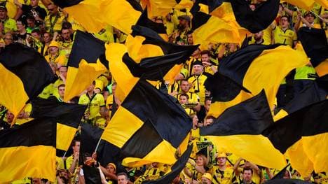Dortmund's fans wave flags ahead the German Cup (DFB Pokal) final football match Eintracht Frankfurt v BVB Borussia Dortmund at the Olympic stadium in Berlin on May 27, 2017. / AFP PHOTO / John MACDOUGALL / RESTRICTIONS: ACCORDING TO DFB RULES IMAGE SEQUENCES TO SIMULATE VIDEO IS NOT ALLOWED DURING MATCH TIME. MOBILE (MMS) USE IS NOT ALLOWED DURING AND FOR FURTHER TWO HOURS AFTER THE MATCH. == RESTRICTED TO EDITORIAL USE == FOR MORE INFORMATION CONTACT DFB DIRECTLY AT +49 69 67880 /         (Photo credit should read JOHN MACDOUGALL/AFP via Getty Images)
