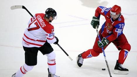 Russia's Oleg Tverdovsky (R) vies with C