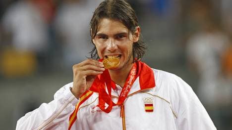 Gold medallist Rafael Nadal of Spain bit