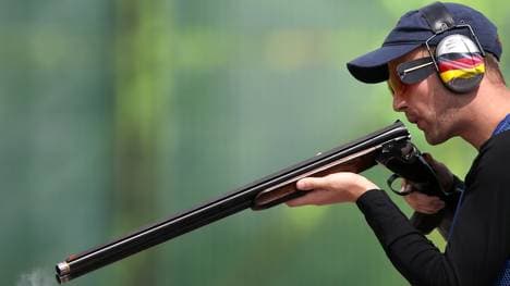 Germany's Ralf Buchheim (L) blows in the