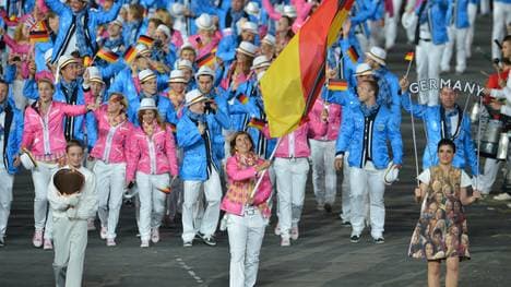Germany's flagbearer Natascha Keller (C)