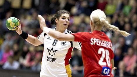 Louise Spellerberg of Denmark (R) tries