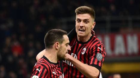 AC Milan's Italian midfielder Giacomo Bonaventura (L) celebrates scoring his team's first goal with AC Milan's Polish forward Krzysztof Piatek during the Italian Cup ((Coppa Italia) round of 8 football match between AC Milan and Torino on January 28, 2020 at the san Siro stadium in Milan. (Photo by MIGUEL MEDINA / AFP) (Photo by MIGUEL MEDINA/AFP via Getty Images)