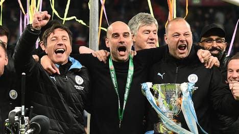 Manchester City's Spanish manager Pep Guardiola (C) celebrates with his backroom staff, Manchester City's Spanish assistant coach Rodolfo Borrell (R) as City players celebrate their win after the English League Cup final football match between Aston Villa and Manchester City at Wembley stadium in London on March 1, 2020. - Manchester City won the game 2-1. (Photo by Glyn KIRK / AFP) (Photo by GLYN KIRK/AFP via Getty Images)