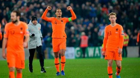 Netherlands' defender Virgil van Dijk (C) celebrates their qualification for the finals on the pitch after the Euro 2020 qualification football match between Northern Ireland and Netherlands at Windsor Park in Belfast on November 16, 2019. (Photo by Mark MARLOW / AFP) (Photo by MARK MARLOW/AFP via Getty Images)