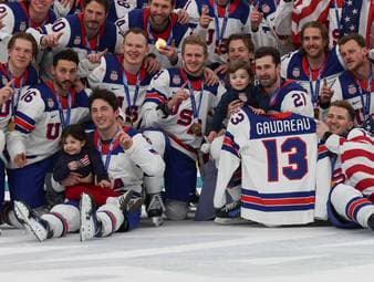 Das Eishockey-Team der USA gedenkt nach dem Gewinn der Gold-Medaille ihrem verstorbenen Teamkollegen Jonny Gaudreau. Auch dessen Kinder sind mit auf dem Eis. 