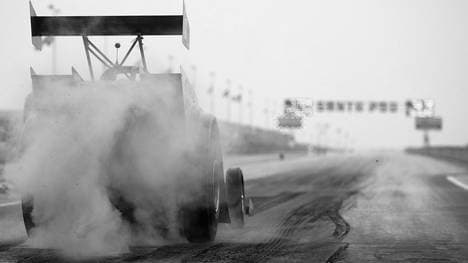 A competitor warms the tyres on his dragster 