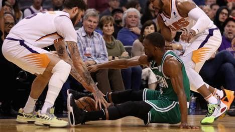 PHOENIX, ARIZONA - NOVEMBER 18: Kemba Walker #8 of the Boston Celtics attempts to control the ball against Tyler Johnson #16 and Jevon Carter #4 of the Phoenix Suns during the second half of the NBA game at Talking Stick Resort Arena on November 18, 2019 in Phoenix, Arizona. The Celtics defeated the Suns 99-85. NOTE TO USER: User expressly acknowledges and agrees that, by downloading and/or using this photograph, user is consenting to the terms and conditions of the Getty Images License Agreement  (Photo by Christian Petersen/Getty Images)